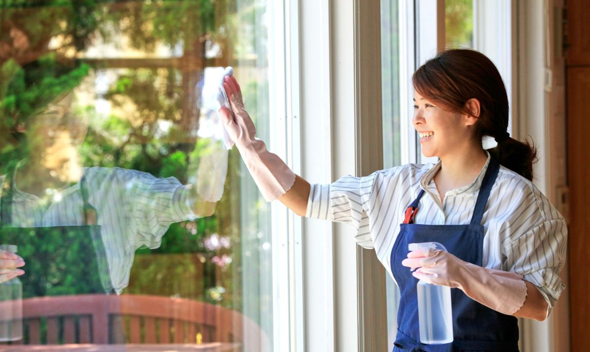 Lady Cleaning glass Window